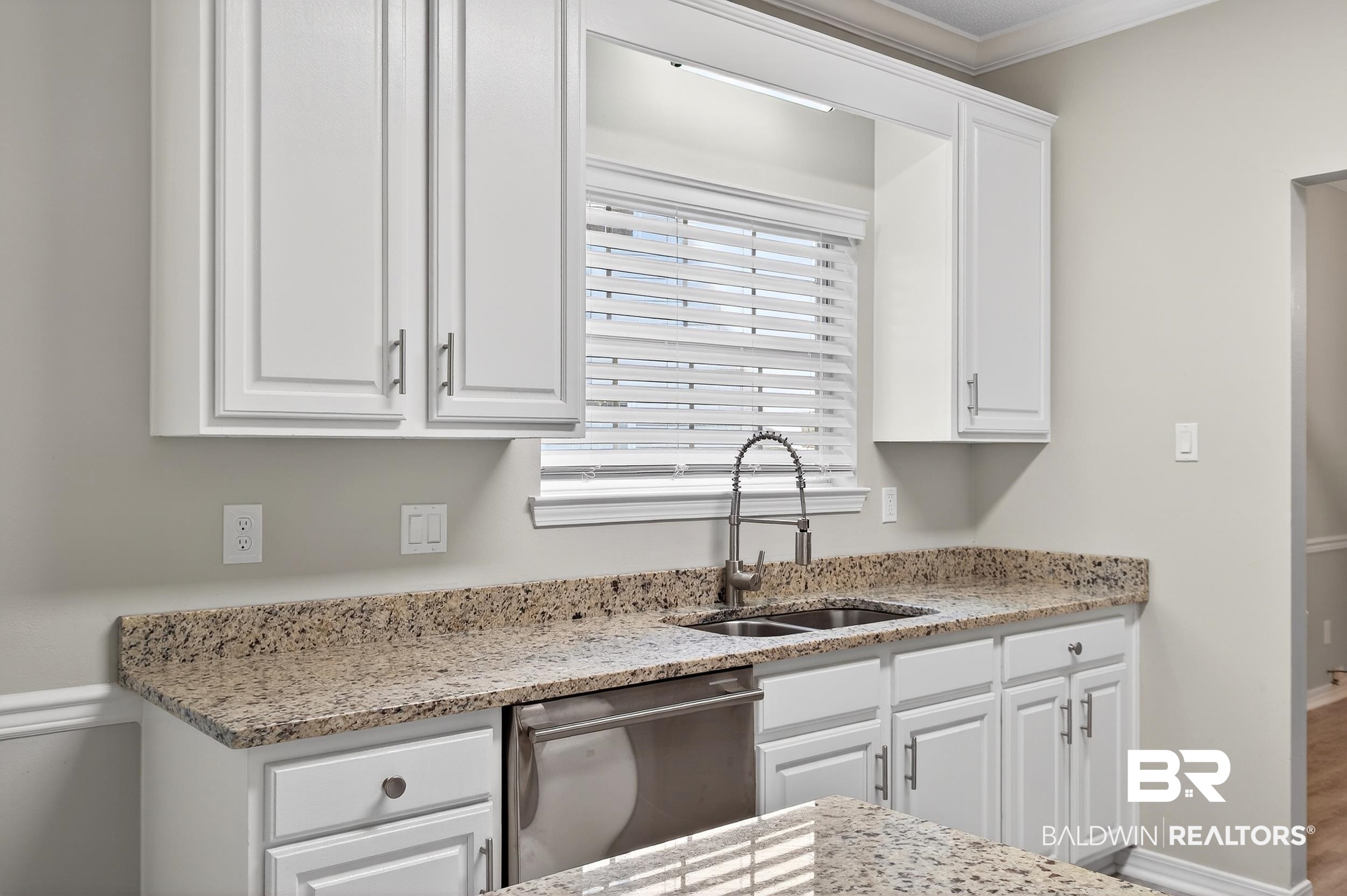 7050 Highpointe Place West Daphne, AL 36527 - Photo 21 of 66 Kitchen with white cabinetry, light stone countertops, stainless steel dishwasher, and ornamental molding
