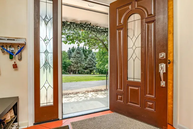 a kitchen with stainless steel appliances granite countertop a refrigerator a stove a sink dishwasher with a dining table and chairs with wooden floor