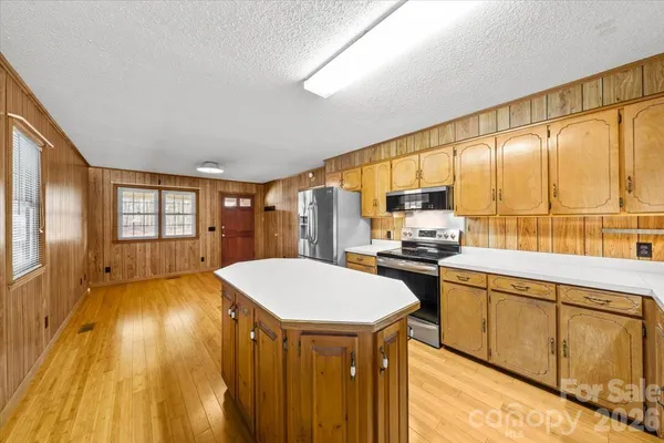 a kitchen with stainless steel appliances granite countertop sink stove and refrigerator
