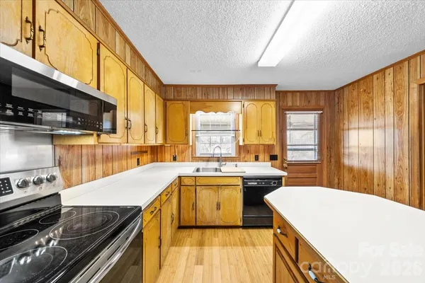 a kitchen with a stove a sink and a refrigerator