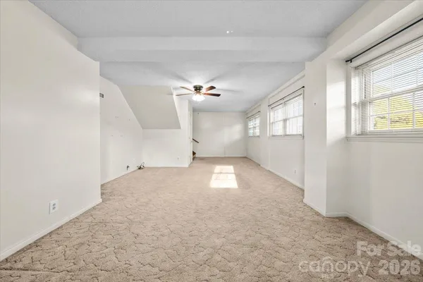 an empty room with a empty space and windows