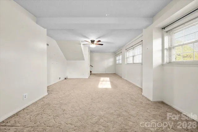 an empty room with a empty space and windows