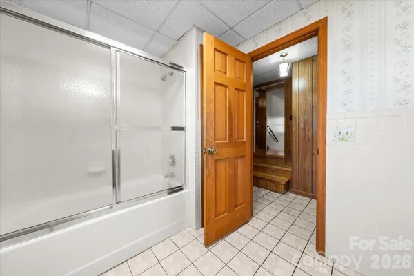 a bathroom with a glass shower door