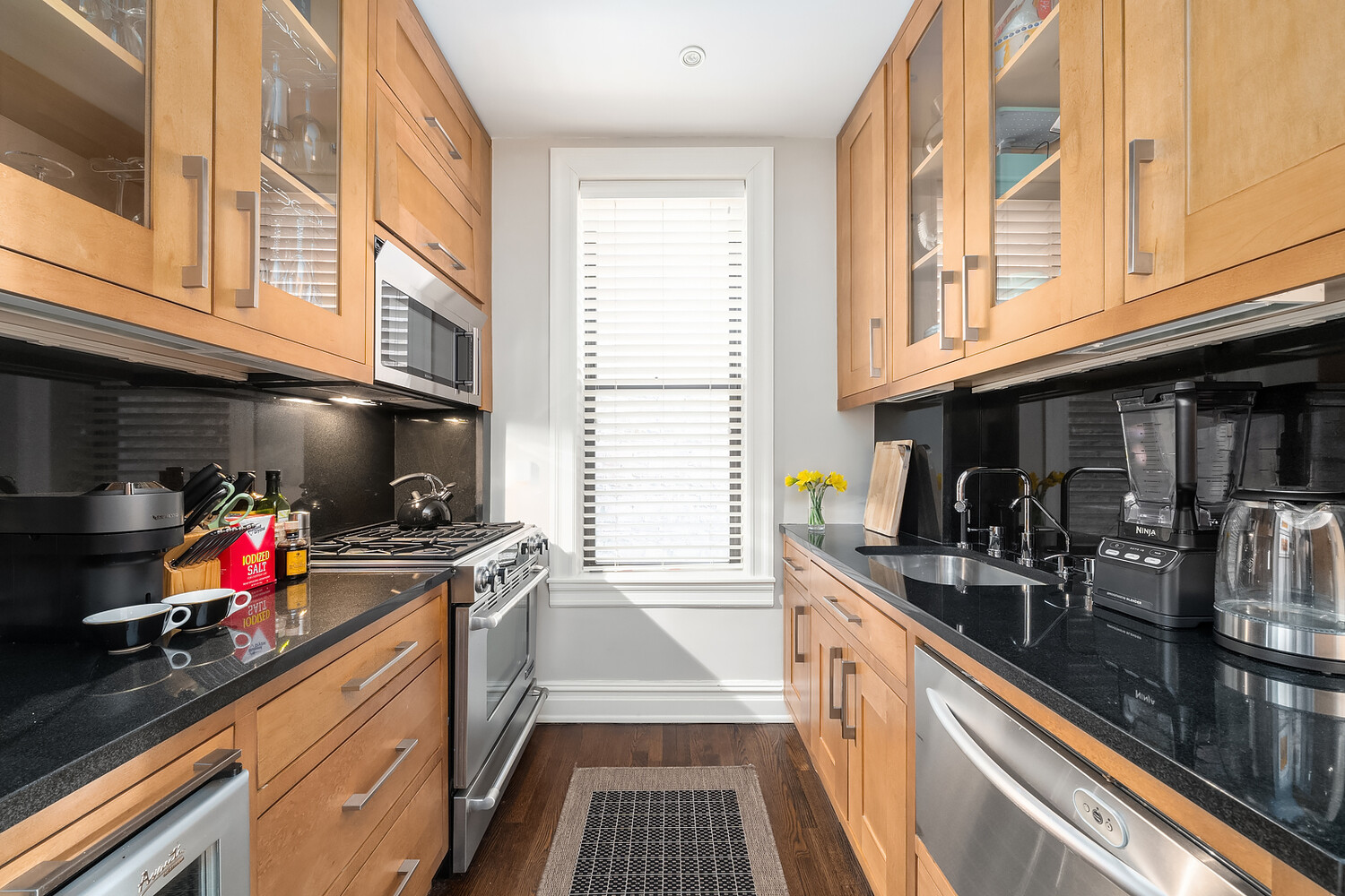 17 East 95th Street, Unit 4R Manhattan, NY 10128 - Photo 3 of 8 a kitchen with a sink a stove and cabinets