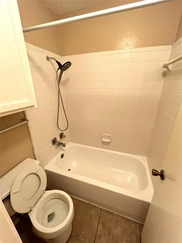 a bathroom with a toilet and a bathtub