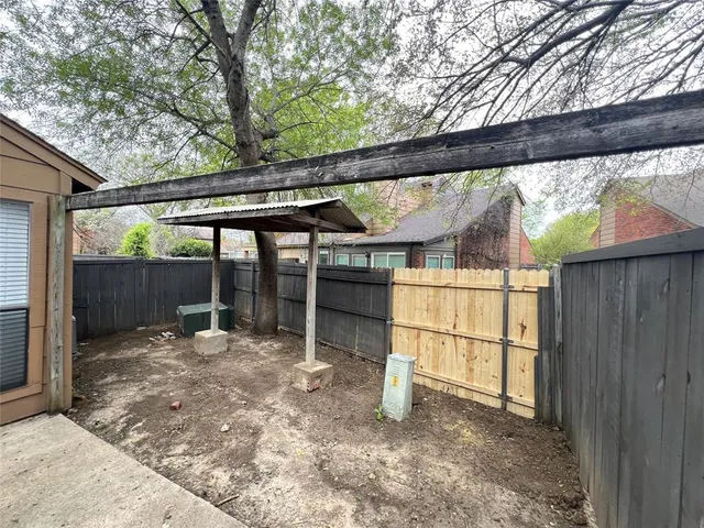a backyard of a house with wooden floor and outdoor seating