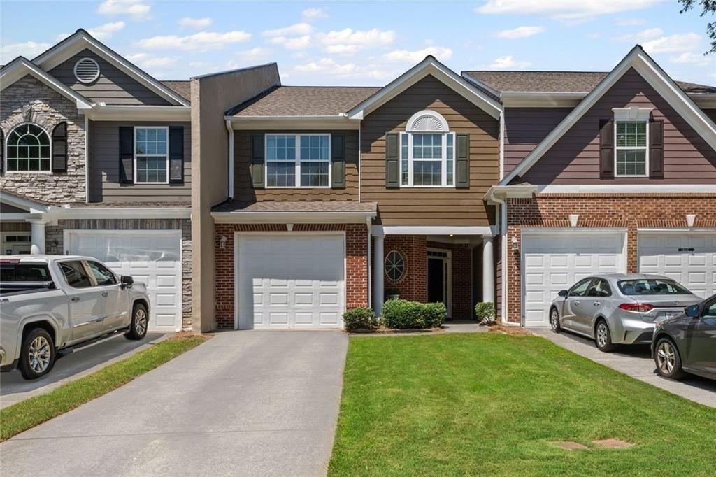 2743 Pierce Brennen Court Northeast Lawrenceville, GA 30043 - Photo 1 of 31 a front view of a house with a garden
