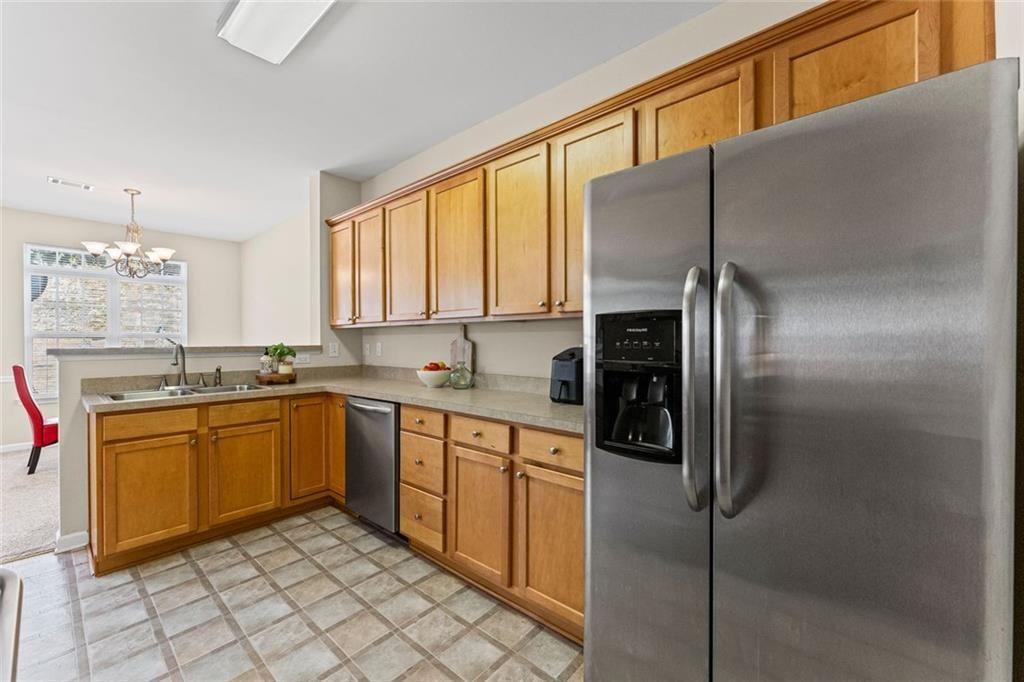 2743 Pierce Brennen Court Northeast Lawrenceville, GA 30043 - Photo 12 of 31 a kitchen with stainless steel appliances granite countertop a refrigerator and a stove top oven