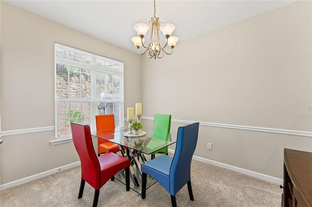 2743 Pierce Brennen Court Northeast Lawrenceville, GA 30043 - Photo 13 of 31 a view of a dining room with furniture and chandelier