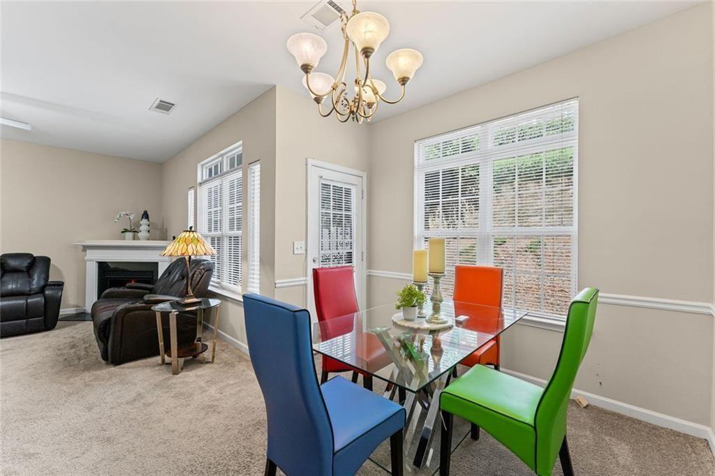 2743 Pierce Brennen Court Northeast Lawrenceville, GA 30043 - Photo 14 of 31 a dining room with furniture a chandelier and a rug