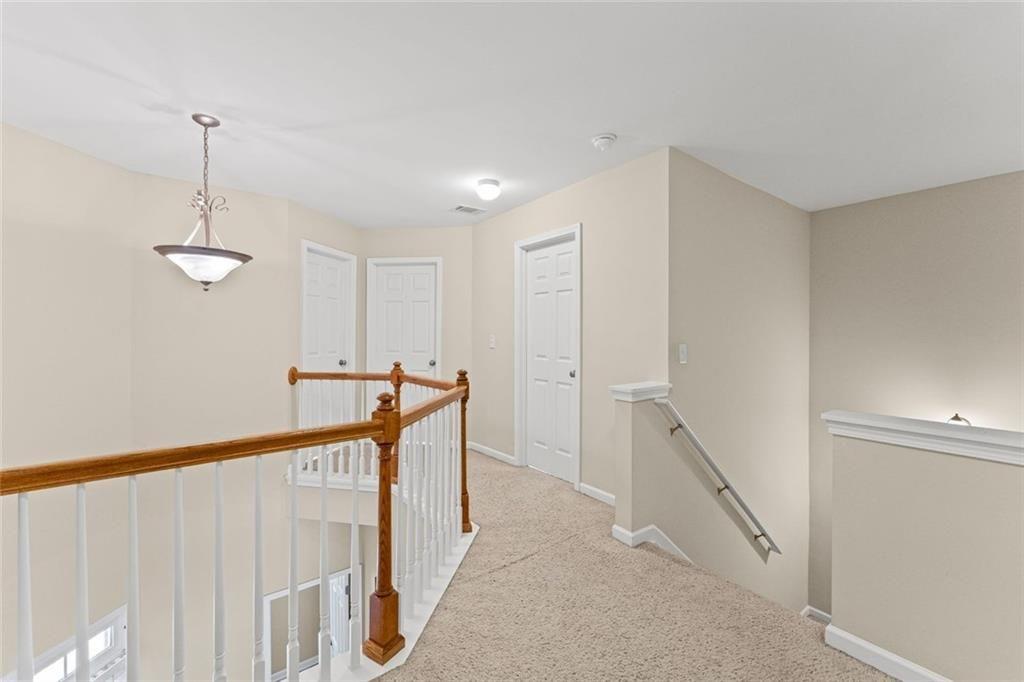 2743 Pierce Brennen Court Northeast Lawrenceville, GA 30043 - Photo 16 of 31 a view of a hallway with a chandelier