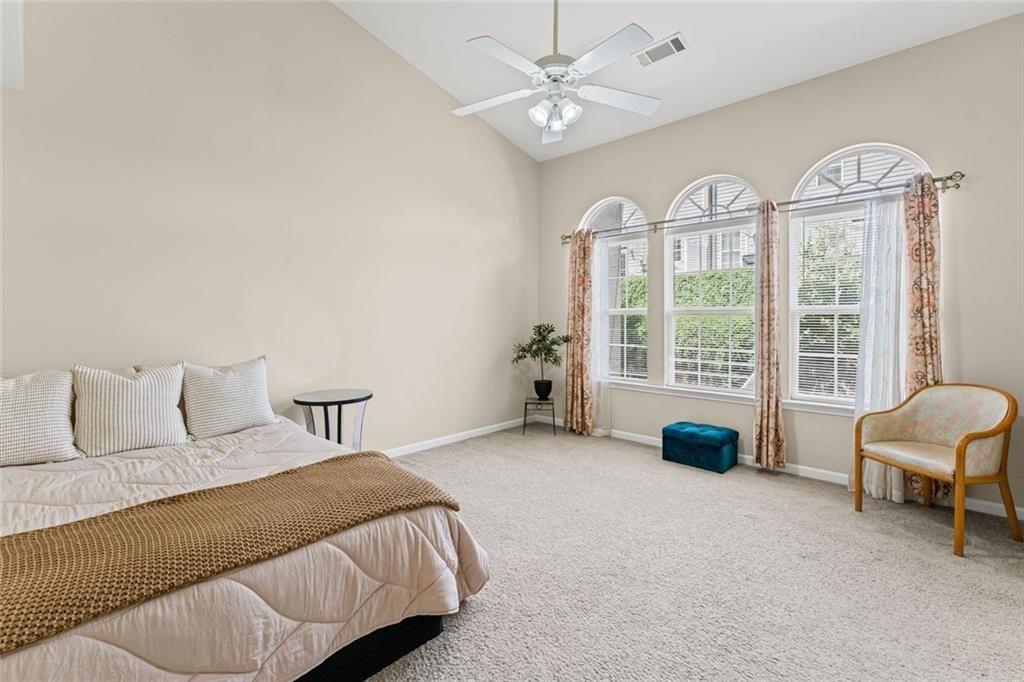 2743 Pierce Brennen Court Northeast Lawrenceville, GA 30043 - Photo 17 of 31 a spacious bedroom with a bed and a large window