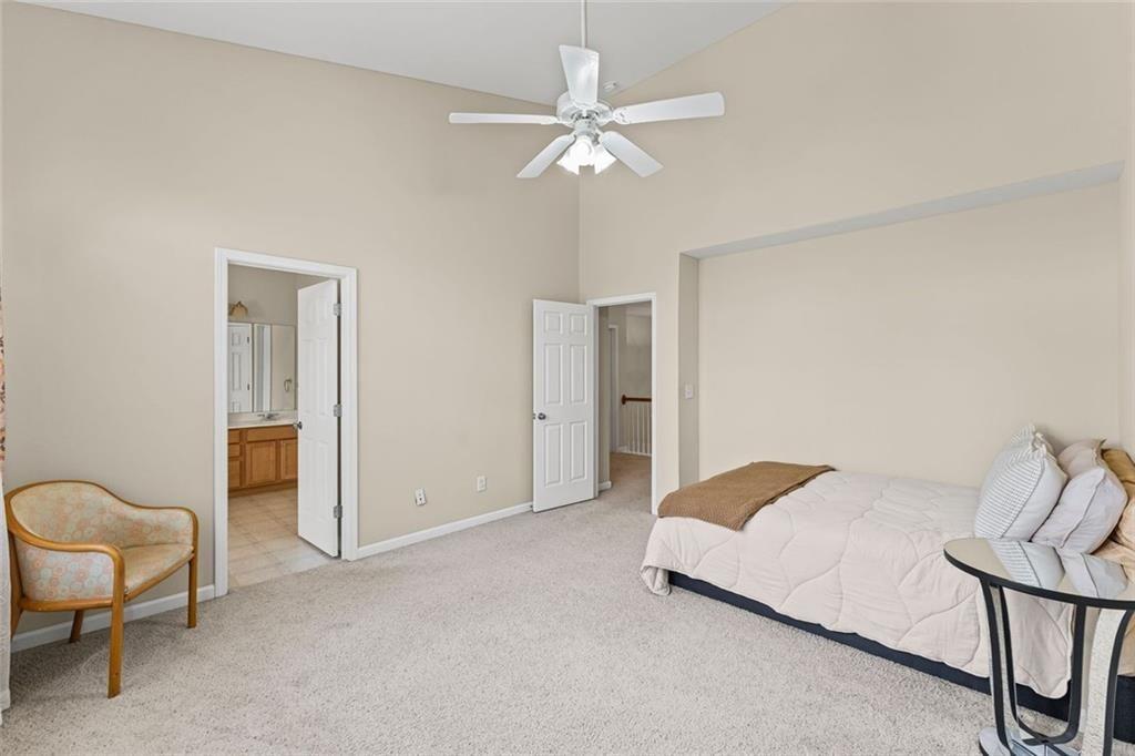 2743 Pierce Brennen Court Northeast Lawrenceville, GA 30043 - Photo 18 of 31 a bed room with a bed and a chair