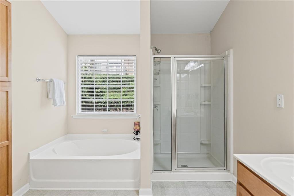 2743 Pierce Brennen Court Northeast Lawrenceville, GA 30043 - Photo 20 of 31 a bathroom with a bathtub and shower