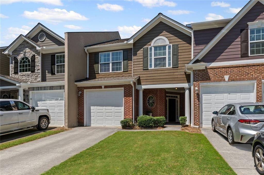 2743 Pierce Brennen Court Northeast Lawrenceville, GA 30043 - Photo 2 of 31 a front view of a house with a yard and garage