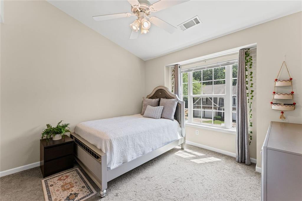 2743 Pierce Brennen Court Northeast Lawrenceville, GA 30043 - Photo 21 of 31 a bedroom with a bed and a window