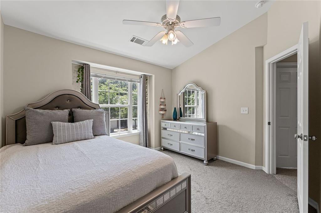2743 Pierce Brennen Court Northeast Lawrenceville, GA 30043 - Photo 22 of 31 a bedroom with a bed and a dresser