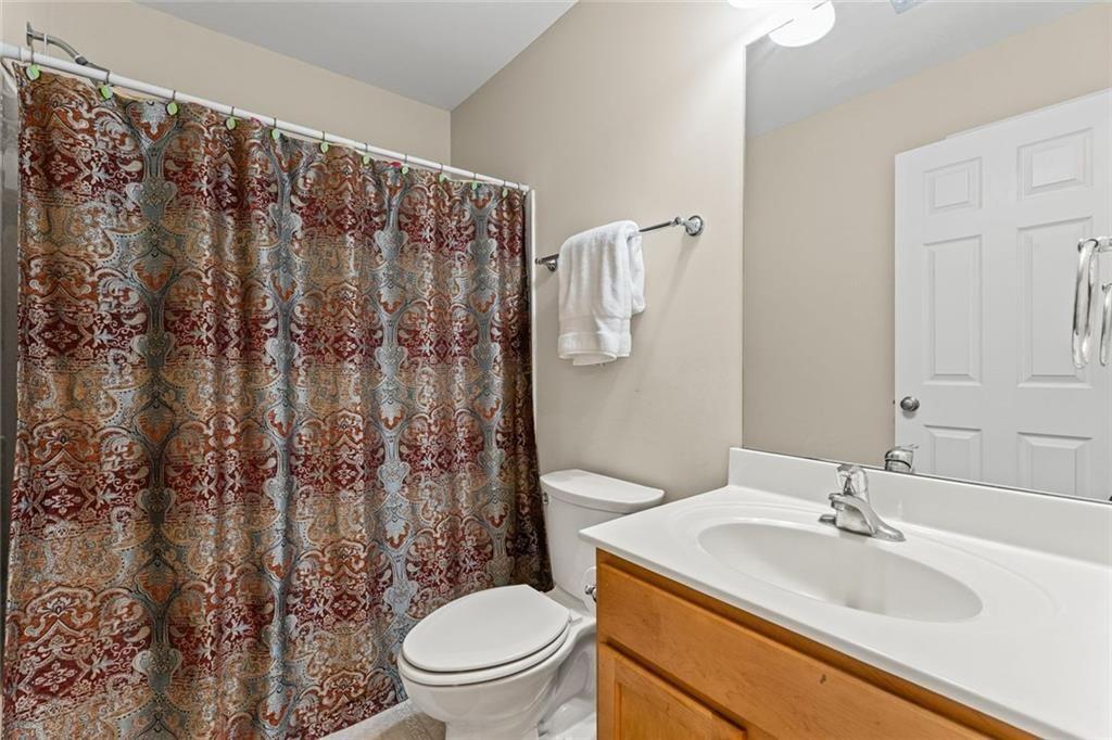 2743 Pierce Brennen Court Northeast Lawrenceville, GA 30043 - Photo 23 of 31 a bathroom with a granite countertop sink toilet and a mirror