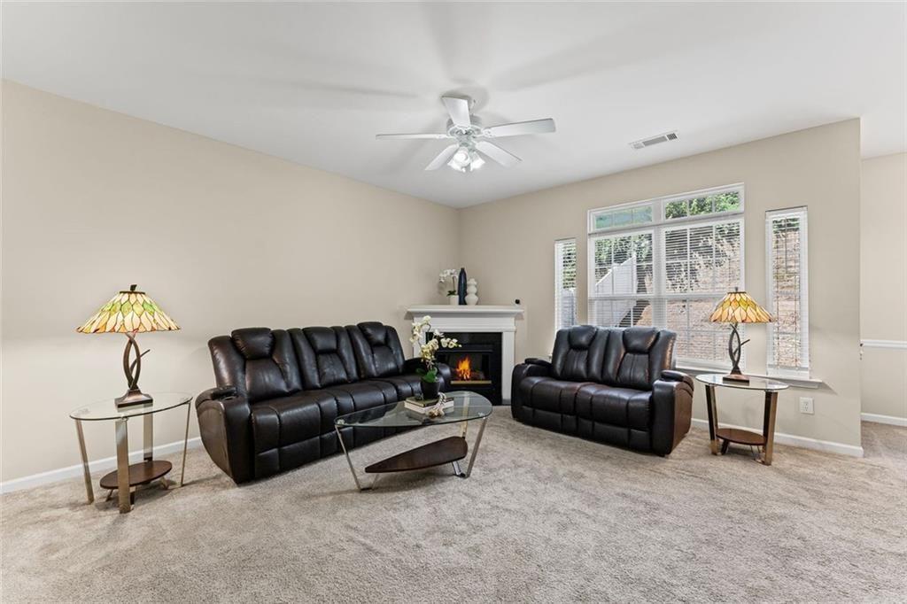 2743 Pierce Brennen Court Northeast Lawrenceville, GA 30043 - Photo 5 of 31 a living room with furniture and a chandelier
