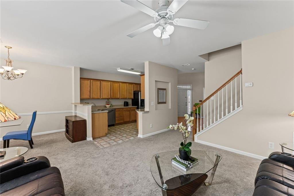 2743 Pierce Brennen Court Northeast Lawrenceville, GA 30043 - Photo 8 of 31 a living room with furniture and a chandelier