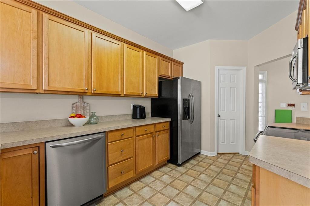 2743 Pierce Brennen Court Northeast Lawrenceville, GA 30043 - Photo 9 of 31 a kitchen with stainless steel appliances granite countertop a refrigerator sink and cabinets