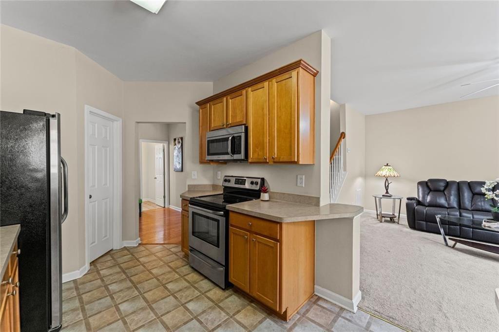 2743 Pierce Brennen Court Northeast Lawrenceville, GA 30043 - Photo 10 of 31 a kitchen with a stove a sink and a refrigerator