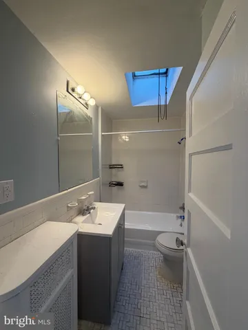 a bathroom with a sink a toilet and bathtub