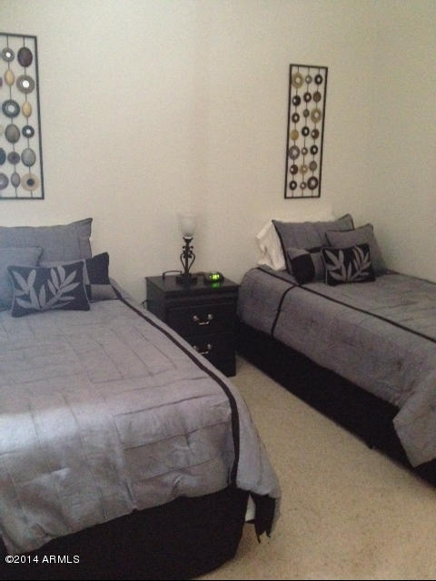 1250 South Rialto, Unit 62 Mesa, AZ 85209 - Photo 19 of 24 a bedroom with a bed and wall painting
