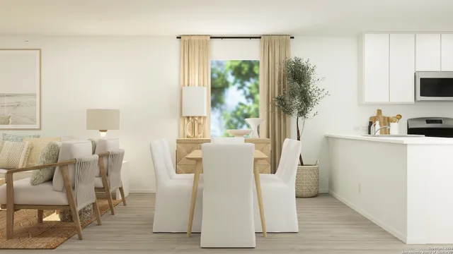 a dining room with furniture and a window