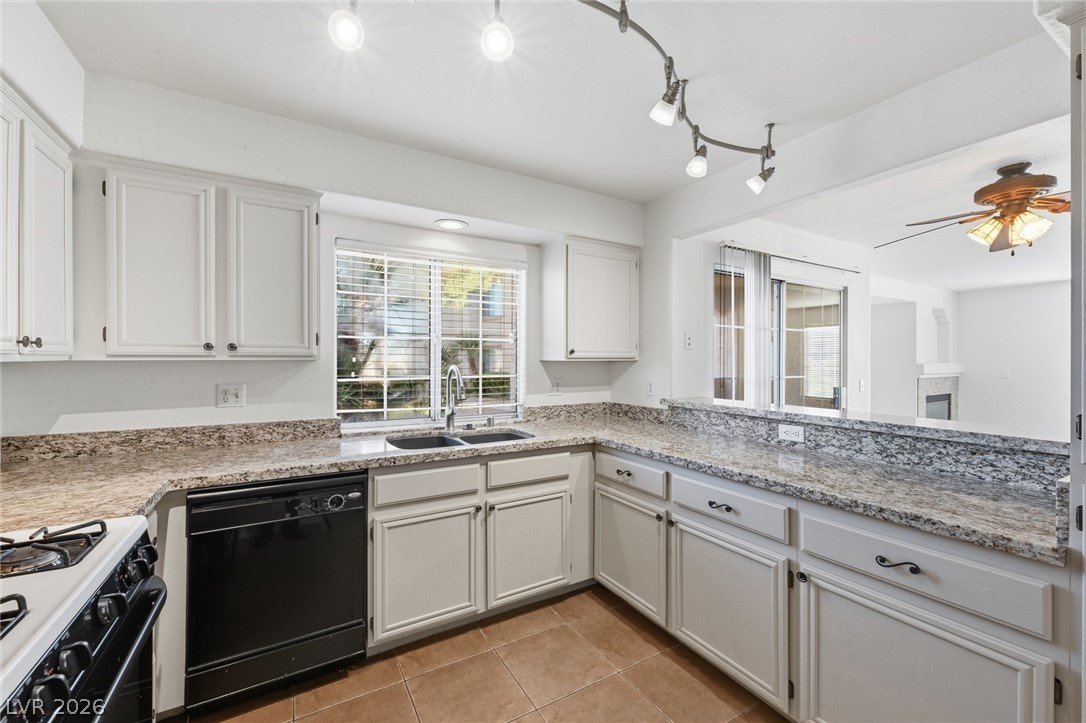 1851 Hillpointe Road, Unit 1311 Henderson, NV 89074 - Photo 14 of 47 Kitchen with dishwasher, white cabinetry, gas range oven, and light tile patterned floors