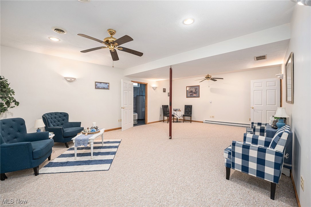 2073 Sexton Road Austinburg, OH 44010 - Photo 25 of 32 Carpeted living area featuring ceiling fan, baseboard heating, and recessed lighting