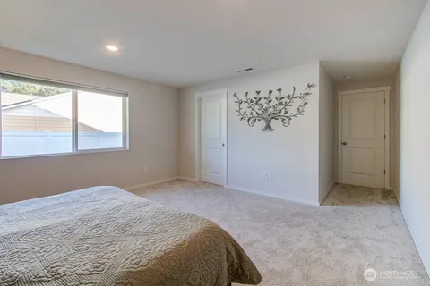 a bedroom with a bed and a window