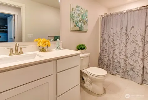 a bathroom with a sink a toilet and a mirror