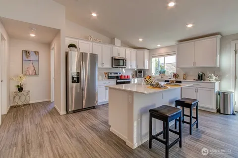 a kitchen with stainless steel appliances a refrigerator and a stove top oven