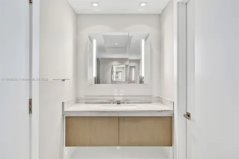 a bathroom with a sink vanity and a mirror