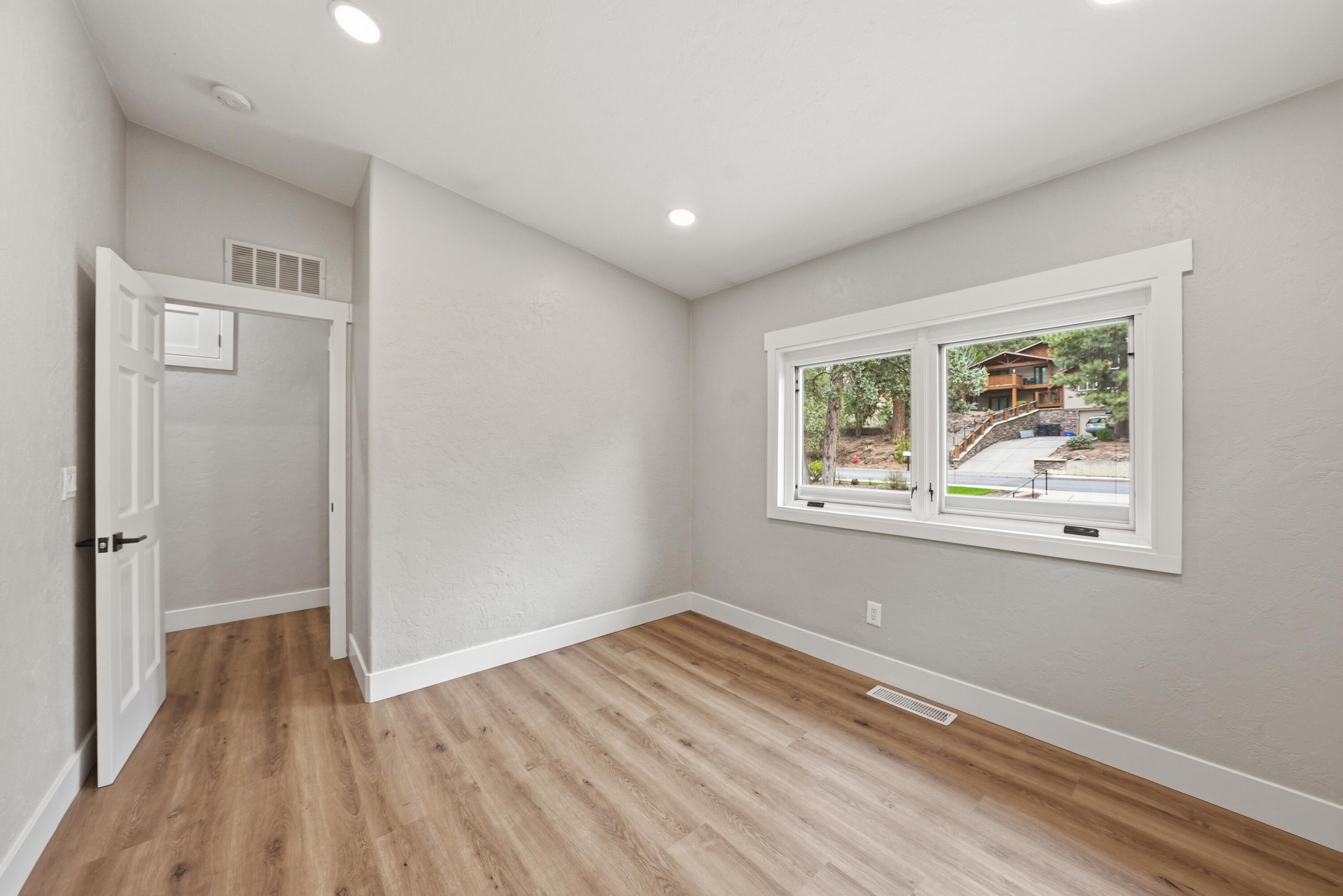 1961 Southwest Knoll Avenue Bend, OR 97702 - Photo 26 of 53 an empty room with wooden floor and windows