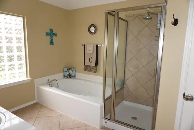a white bath tub sitting next to a shower
