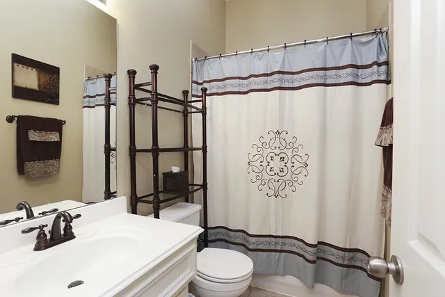 a bathroom with a sink toilet and shower