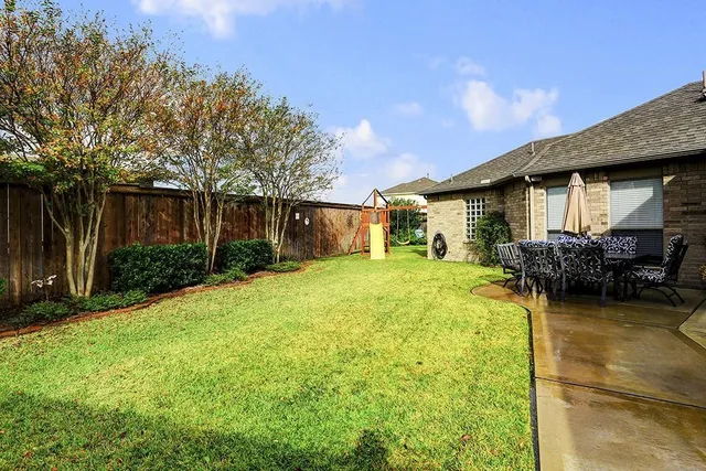 a house view with swimming pool and garden space