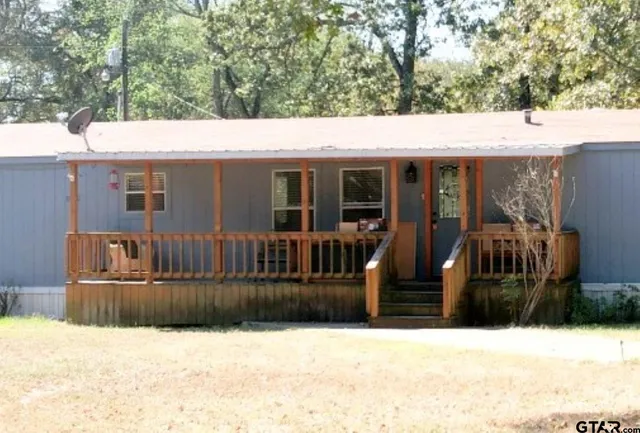 a bedroom with furniture and a wooden floor