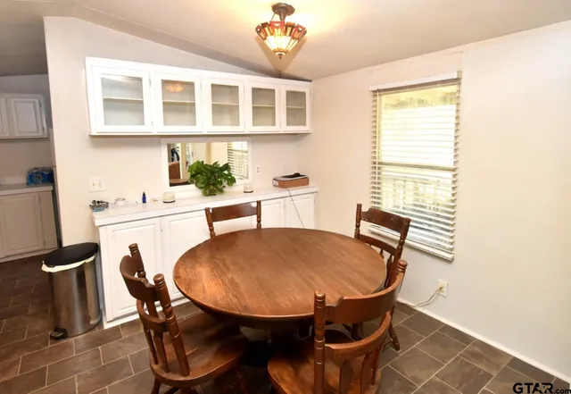 a kitchen with white cabinets and appliances