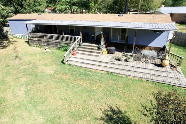 a view of house with swimming pool and furniture
