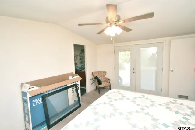 a bedroom with a bed and a painting on the wall