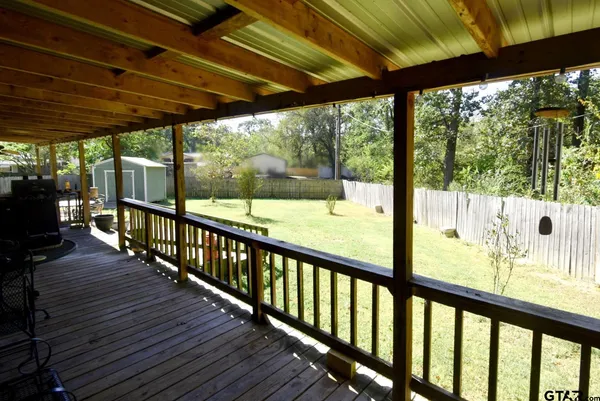 a backyard of a house with basket ball court and a stove