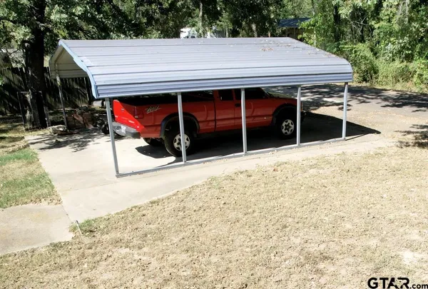 a view of a house with wooden fence
