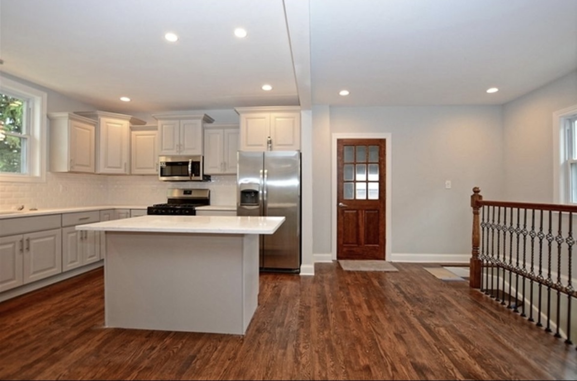 Undisclosed Address Chicago, IL 60628 - Photo 12 of 27 a kitchen with kitchen island a sink wooden floor and stainless steel appliances