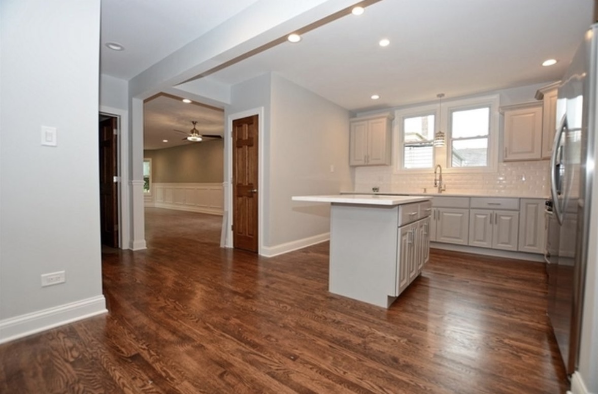 Undisclosed Address Chicago, IL 60628 - Photo 15 of 27 a large kitchen with wooden floor and a sink
