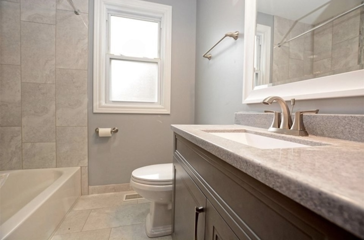 Undisclosed Address Chicago, IL 60628 - Photo 16 of 27 a bathroom with a granite countertop sink a toilet and bathtub