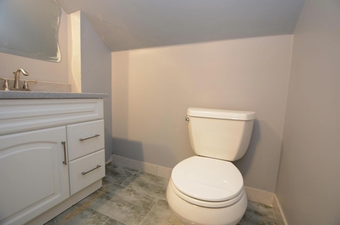 Undisclosed Address Chicago, IL 60628 - Photo 21 of 27 a bathroom with a toilet and a sink