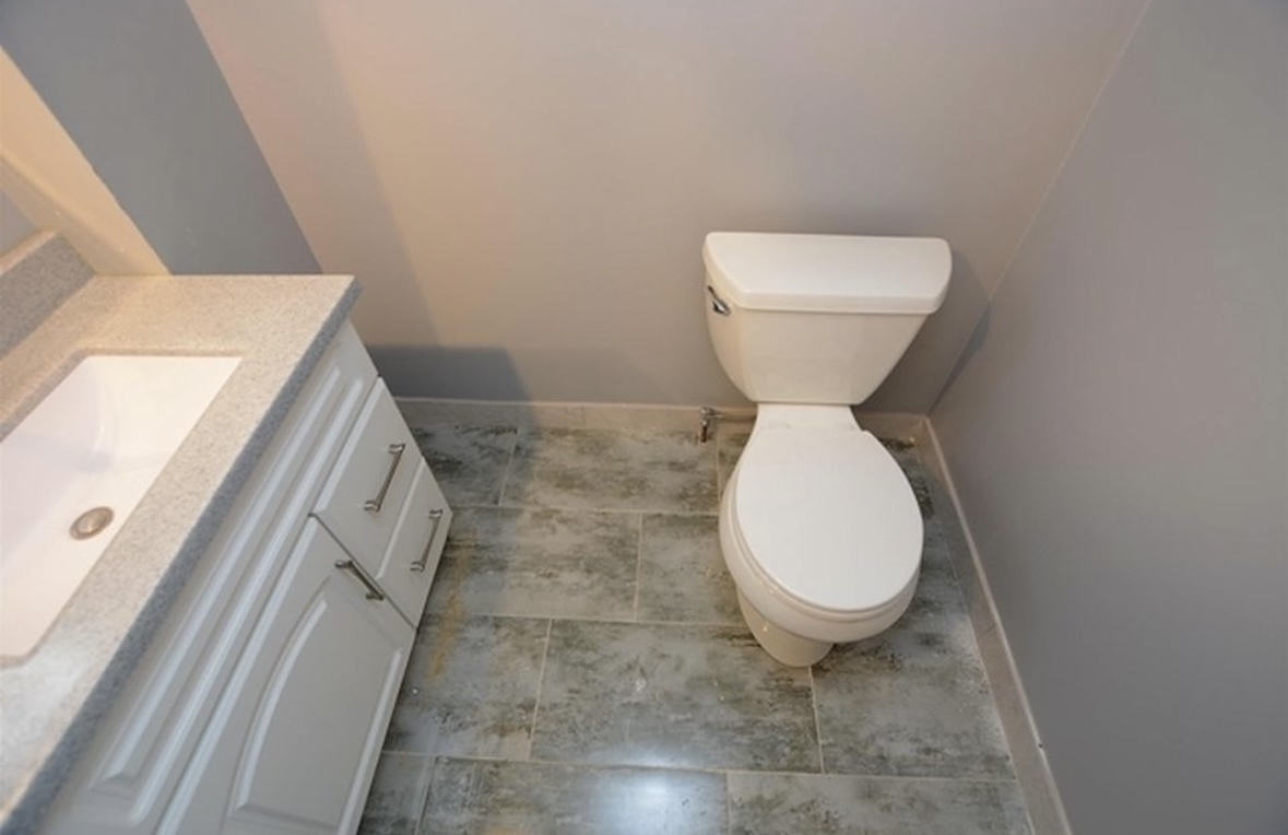 Undisclosed Address Chicago, IL 60628 - Photo 22 of 27 a bathroom with a toilet and a sink